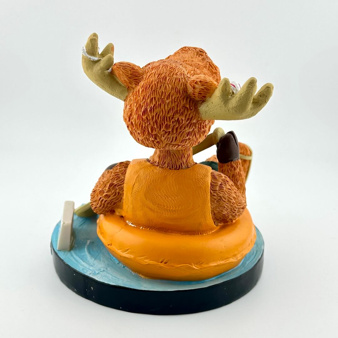 Figurine of a moose on an inflatable ring with a white background
