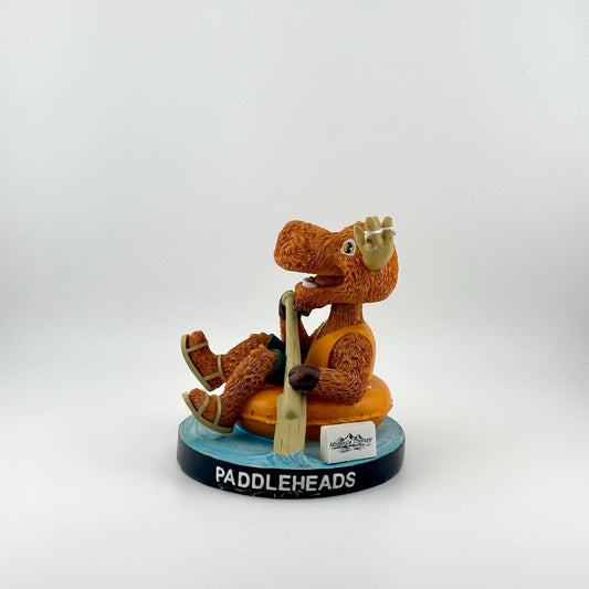 Orange anthropomorphic moose in vest & sandals floating in inner tube with bat as oar. Baseball in horns.