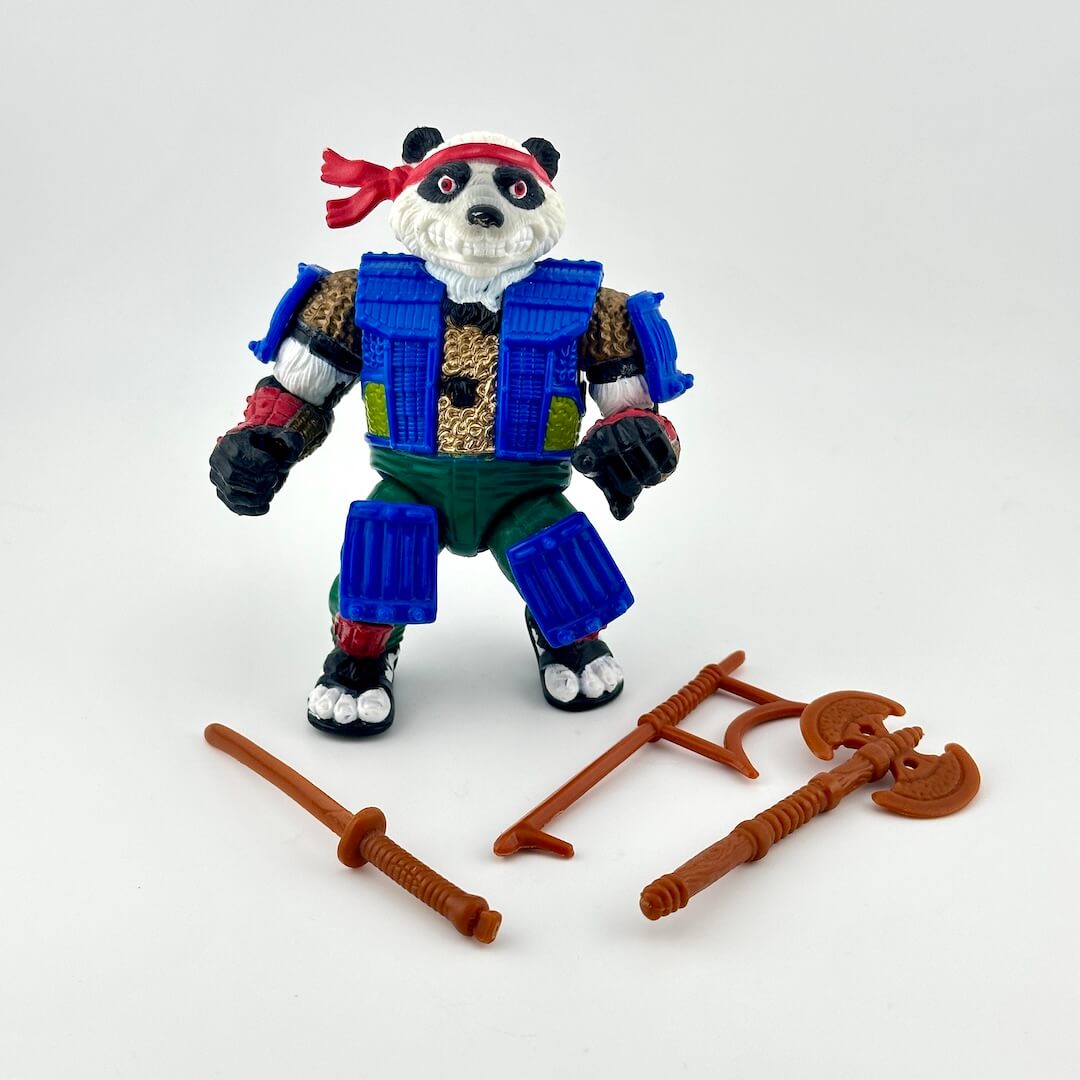 TMNT action figure with accessories on white background. 