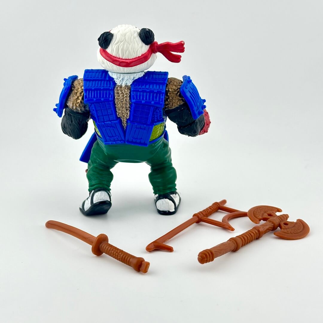 TMNT action figure with accessories on white background. 