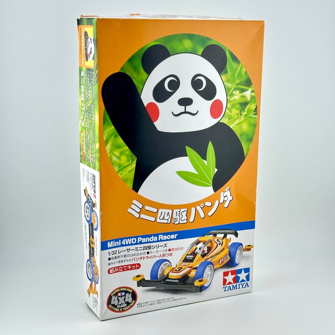 Tamiya Mini 4WD Panda Racer toy box, featuring a panda graphic on an orange background.