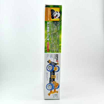 Side view of packaging with diagram of model racecar and panda graphic.