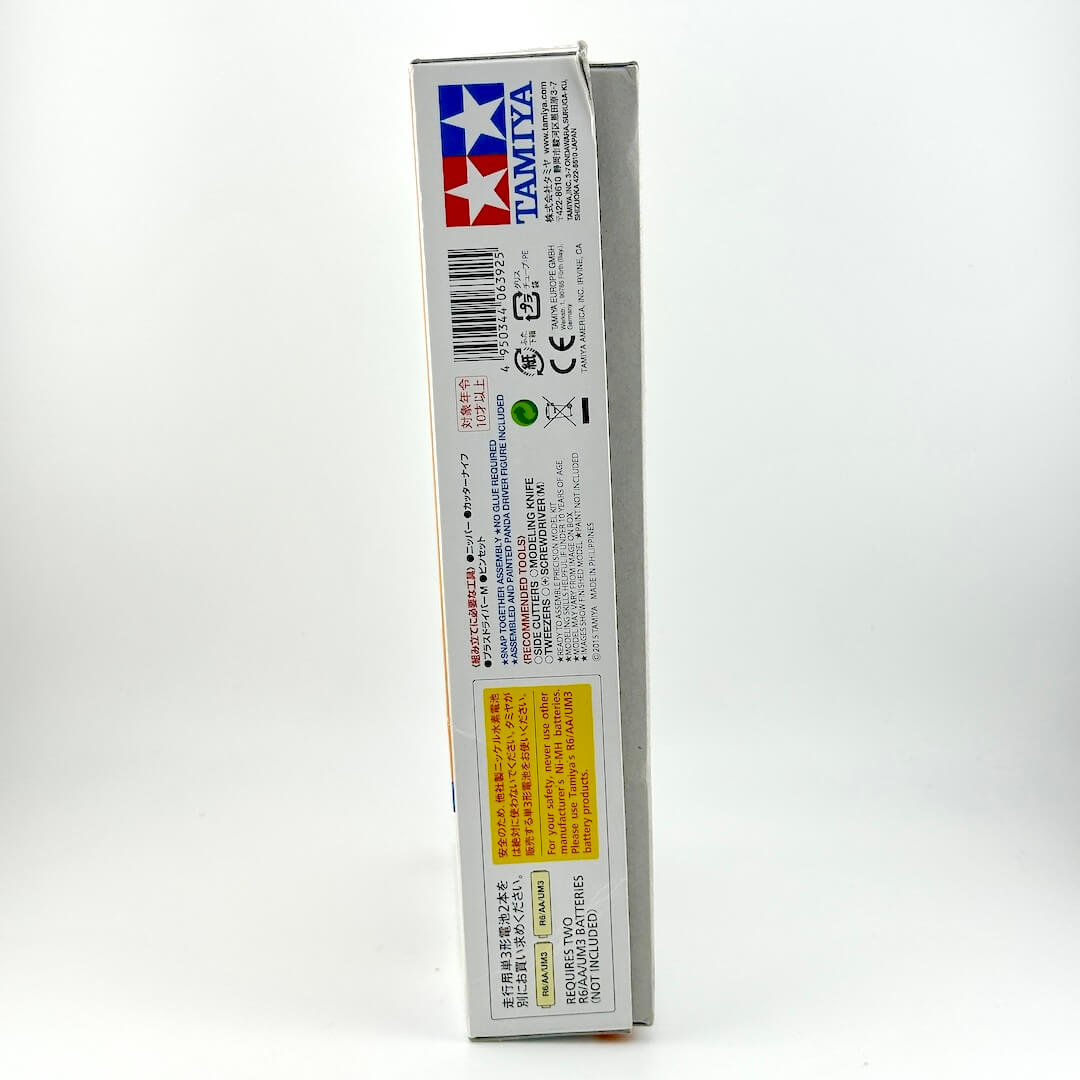 The side panel of a Tamiya model kit box, showing the brand logo, barcode, and various regulatory text and icons.