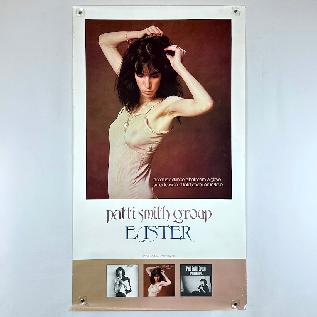 Poster of Patti Smith Group's 'Easter' album with a woman adjusting her hair.