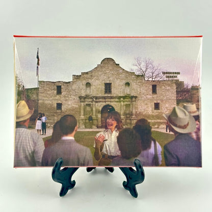 Backside of packaging for postcard set featuring image of the Alamo and tour guide. 