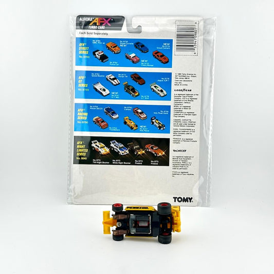 Toy car in front of its packaging with AFX and Tomy branding on a white background