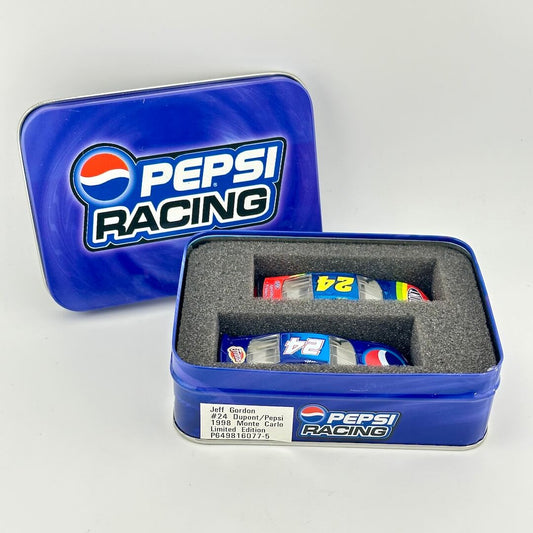 A blue metal Pepsi Racing tin with its lid propped behind the open tin, holding miniature stock car replicas. 