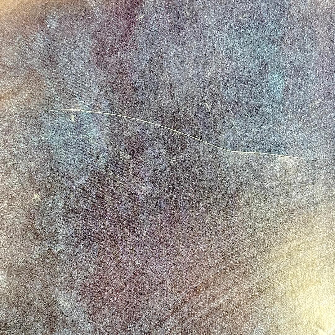 Scratch/crease to face.