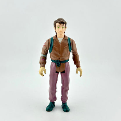 Action figure in a brown jacket and purple pants on a white background