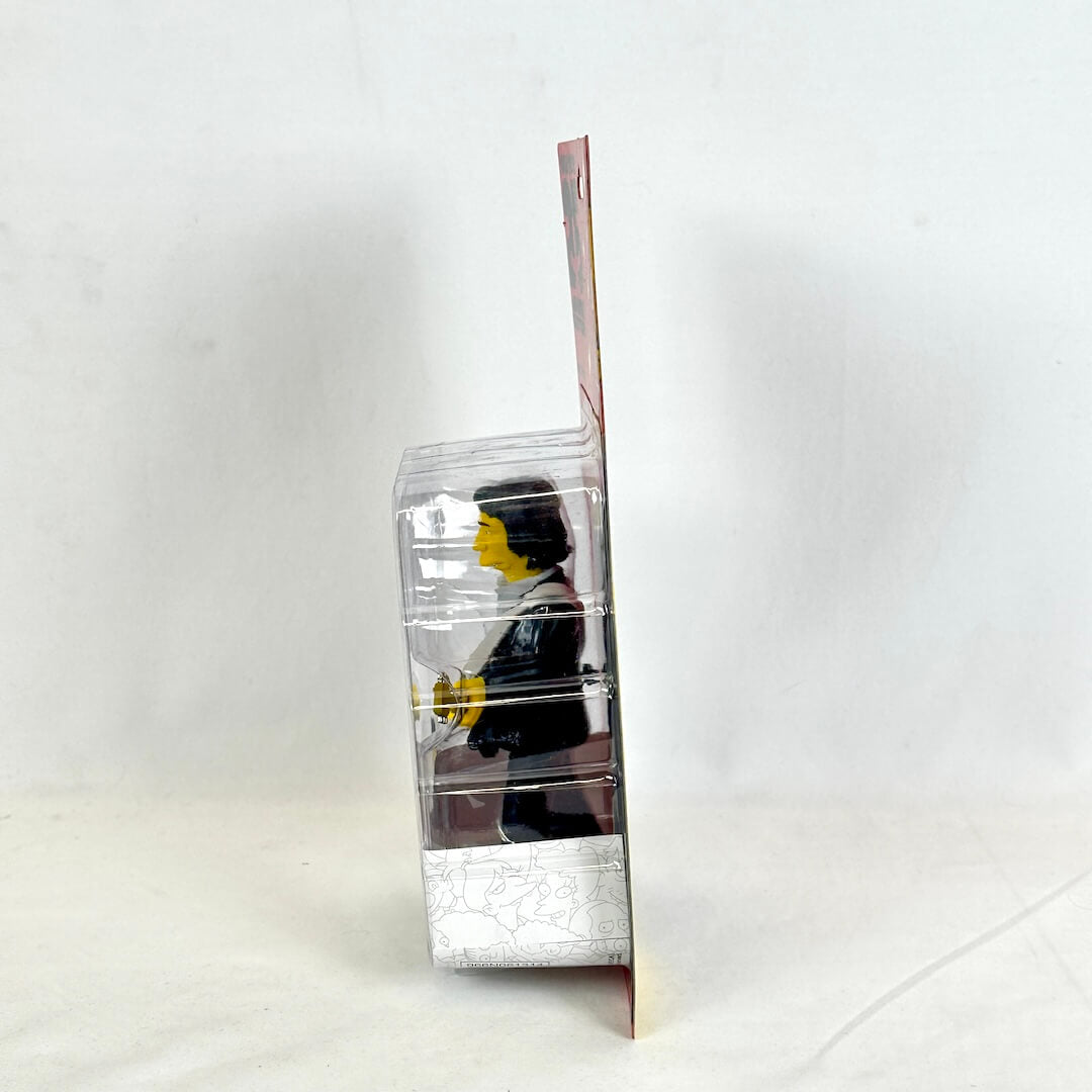 Clear plastic packaging with a small figure inside on a white background