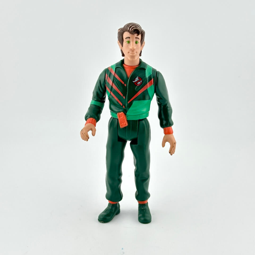 Action figure in green and red outfit on a white background