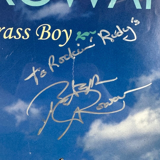 Close-up of silver marker signature at center of poster. 
