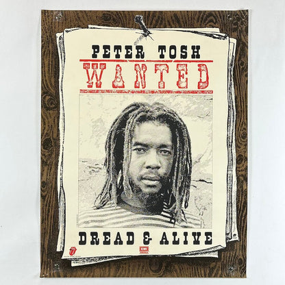 Poster of Peter Tosh with text 'WANTED' and 'Dread & Alive' on a wooden background