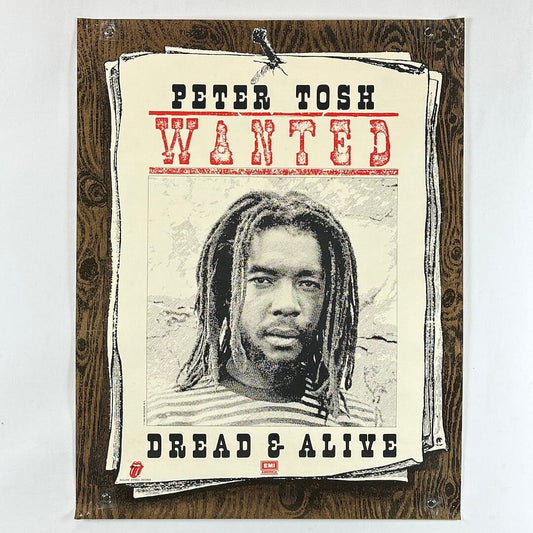 Poster of Peter Tosh with text 'WANTED' and 'Dread & Alive' on a wooden background