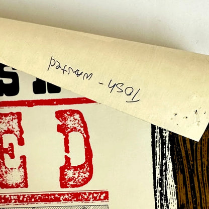 Top right corner bent down to show artist name written in pen on back. 