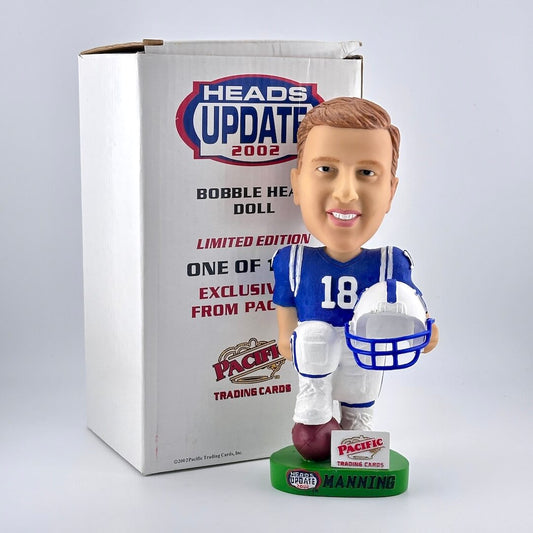 Football player bobblehead in blue jersey holding helmet with box against white background. 