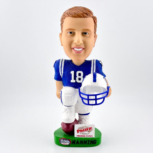 Football player bobblehead in blue jersey holding white helmet against white background. 