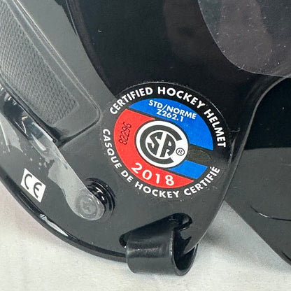 Certified hockey helmet label with S.A. logo on a black background