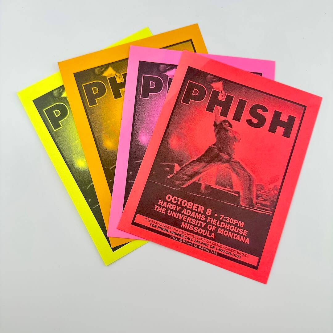 Four Phish concert posters in different colors on a light gray background