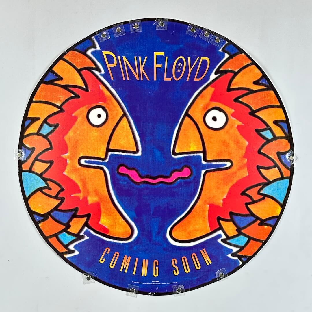 Circular artwork with colorful faces and 'Pink Floyd Coming Soon' text on a blue background