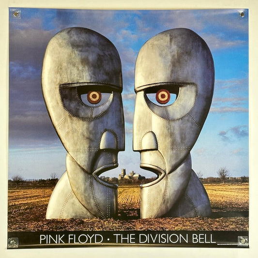Poster of album cover for Pink Floyd's 'The Division Bell' featuring two metallic faces with a landscape in the background.