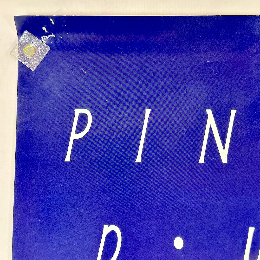 Top left corner with pin holes. 