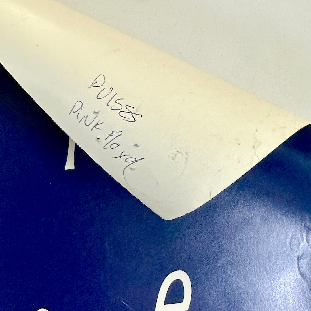 Top right corner rolled down to show artist name in pen on reverse side. 