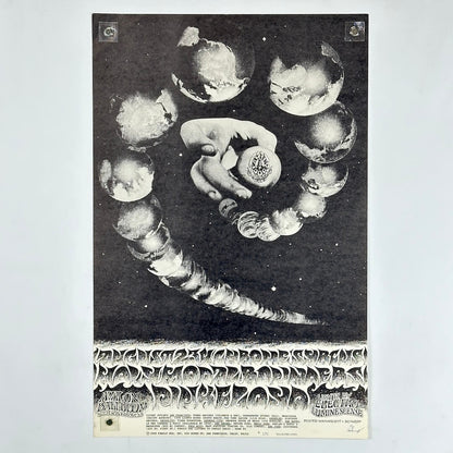 Black and white poster with a hand holding a sphere surrounded by celestial bodies on a light gray background.