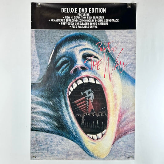 Poster for 'The Wall' deluxe DVD edition with a graphic design of a face and text.