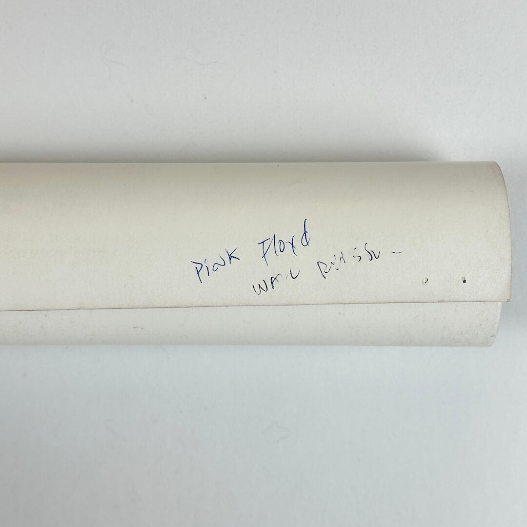 Roll of paper with handwritten text on a white background