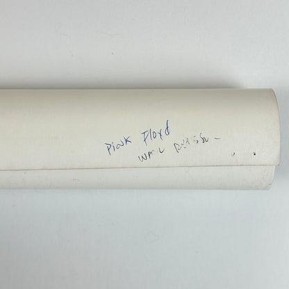 Roll of paper with handwritten text on a white background