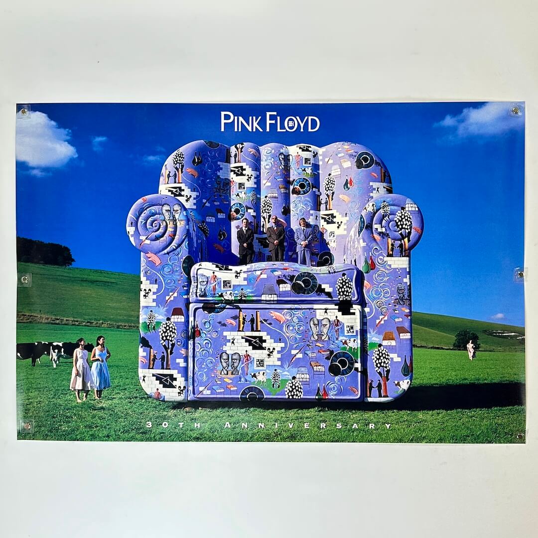 Decorative chair with artistic design in a field, featuring 'Pink Floyd' branding.