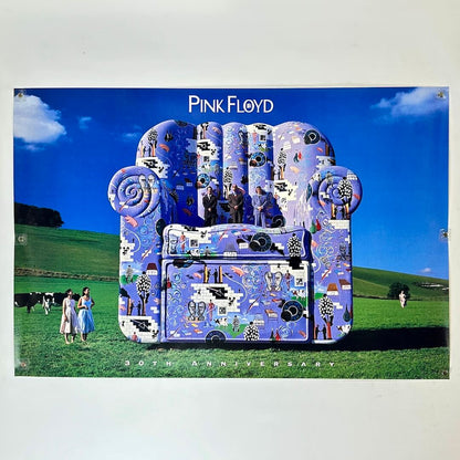 Decorative chair with artistic design in a field, featuring 'Pink Floyd' branding.