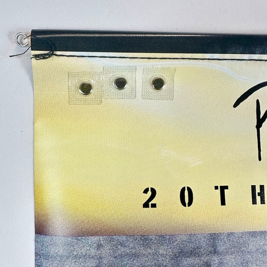 Top left corner of banner with some loose threads.