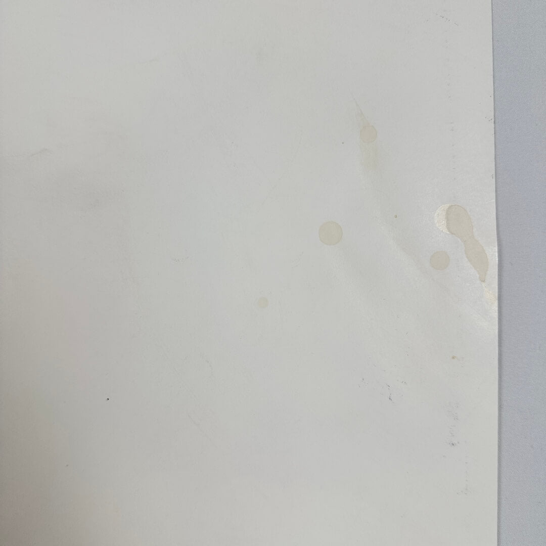 Close up of liquid drips on backside of poster. 