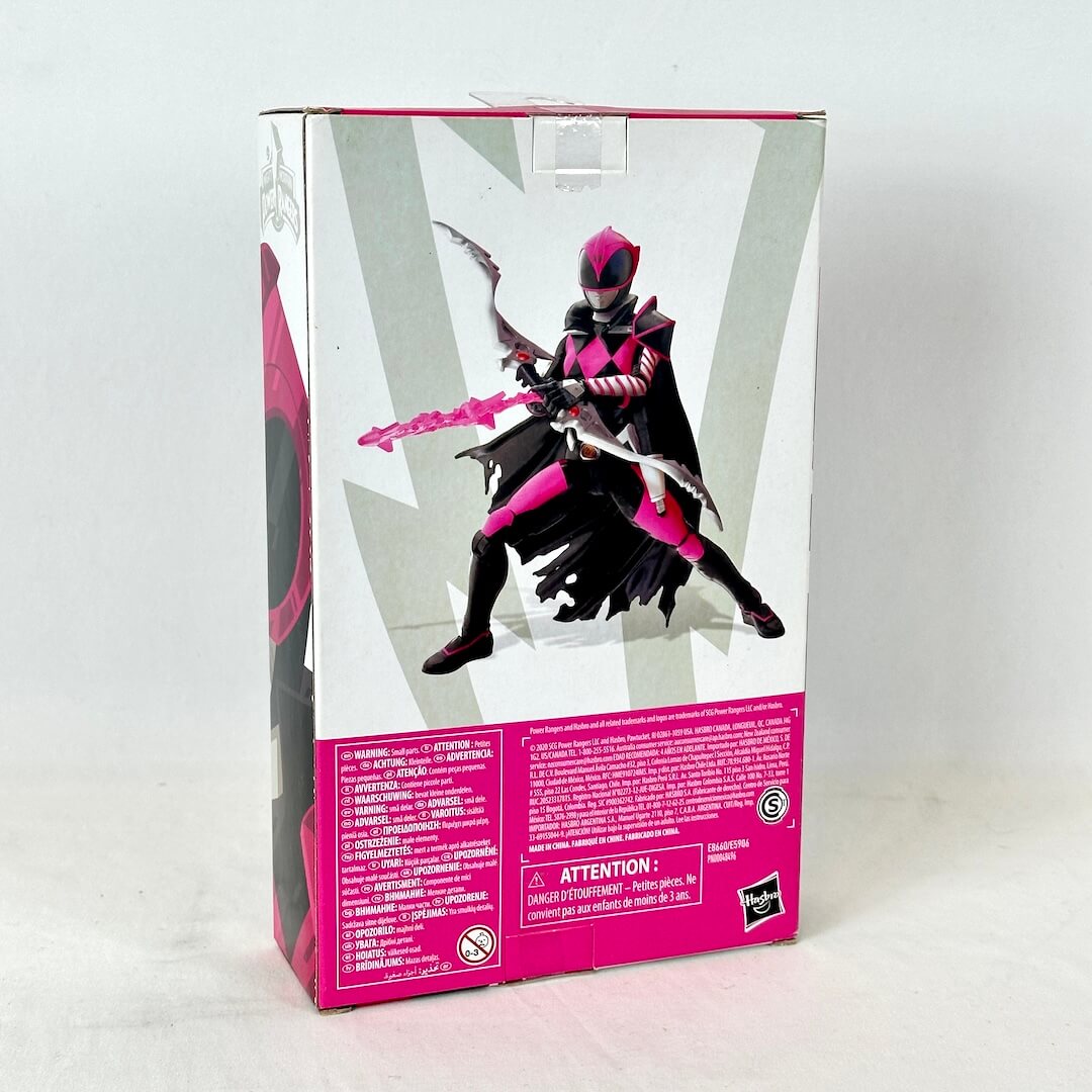 Back of packaging with image of posed action figure above warnings and product information. 