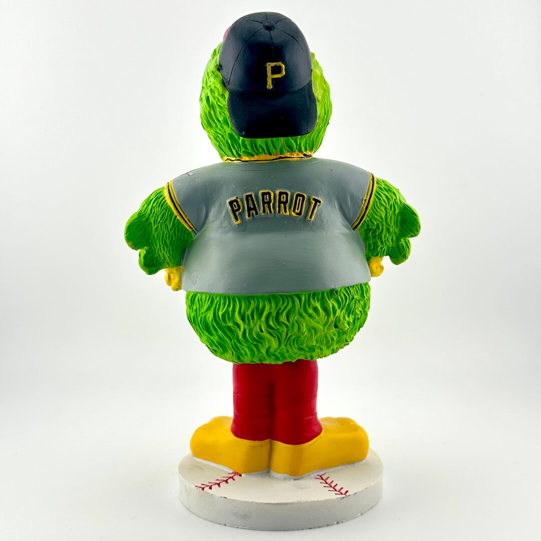 Green parrot figurine wearing a gray jersey with 'PARROT' and a black cap on a white background