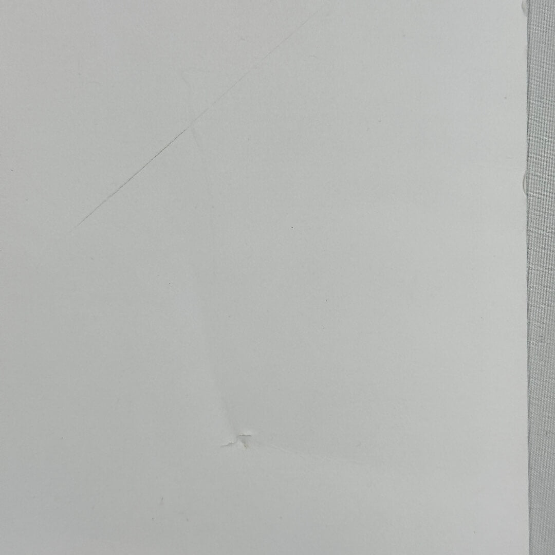 Close up of dent on side of poster. 