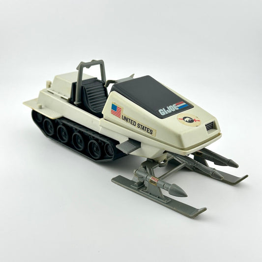 Toy snowmobile with 'United States' and 'G.I. Joe' branding on a white background