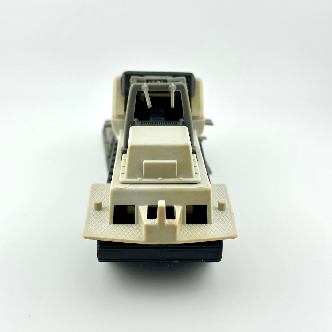 Back view of toy snowmobile against white background. 