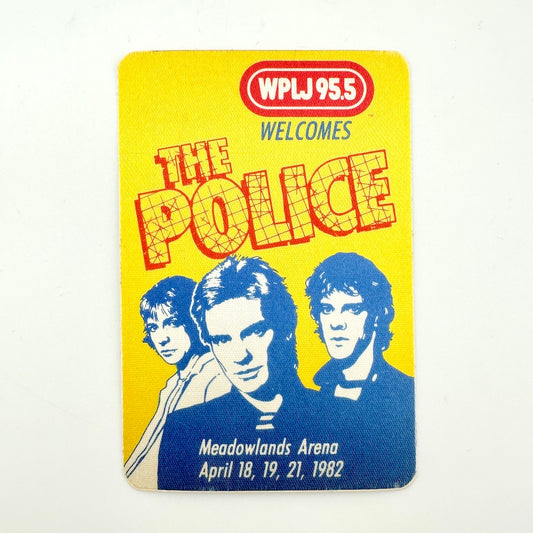 A vintage yellow WPLJ 95.5 radio station pass featuring 'The Police' band, with blue and red graphics and photos of the three band members.