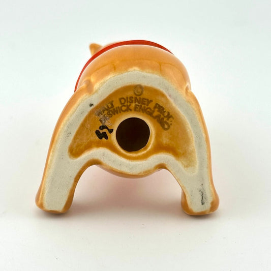 Underside view of Pooh figurine with 'Walt Disney' branding and 'Beswick, England' maker's mark. 