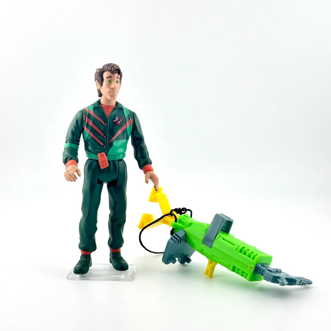 Toy figure in a green outfit with a green and yellow vehicle on a white background