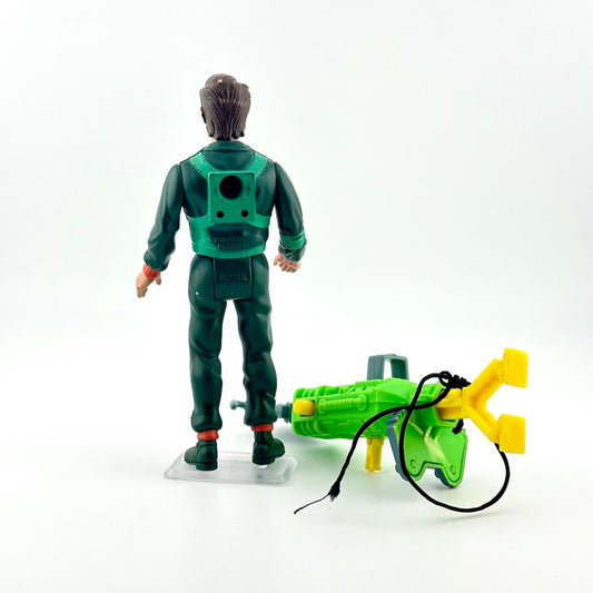 Toy figure in green space suit with a green and yellow weapon on a white background