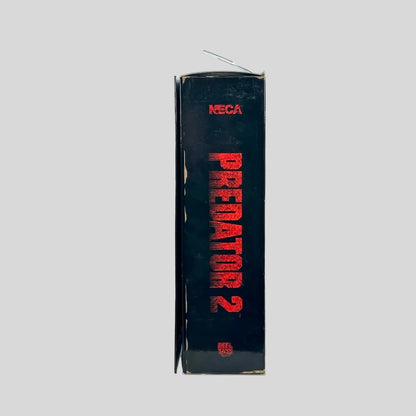 A vintage NECA Predator 2 box standing upright, showing the spine with red text on a black background.