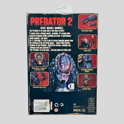 Back of a Predator 2 toy packaging box, showing character art, feature callouts, and NECA branding on a light gray background.