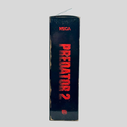 A vintage NECA Predator 2 toy box standing upright on a light gray background. 