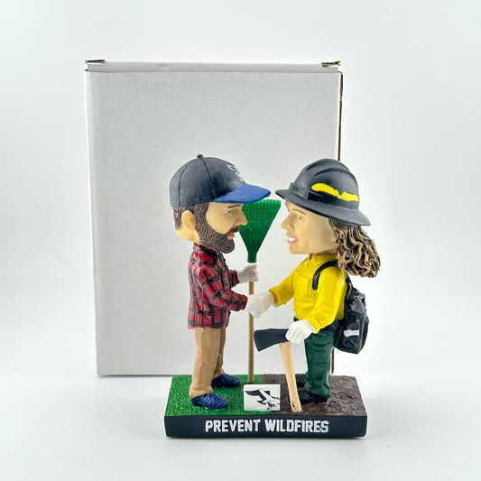 Bobbleheads of a man and woman in outdoor gear with 'Prevent Wildfires' text on a white background