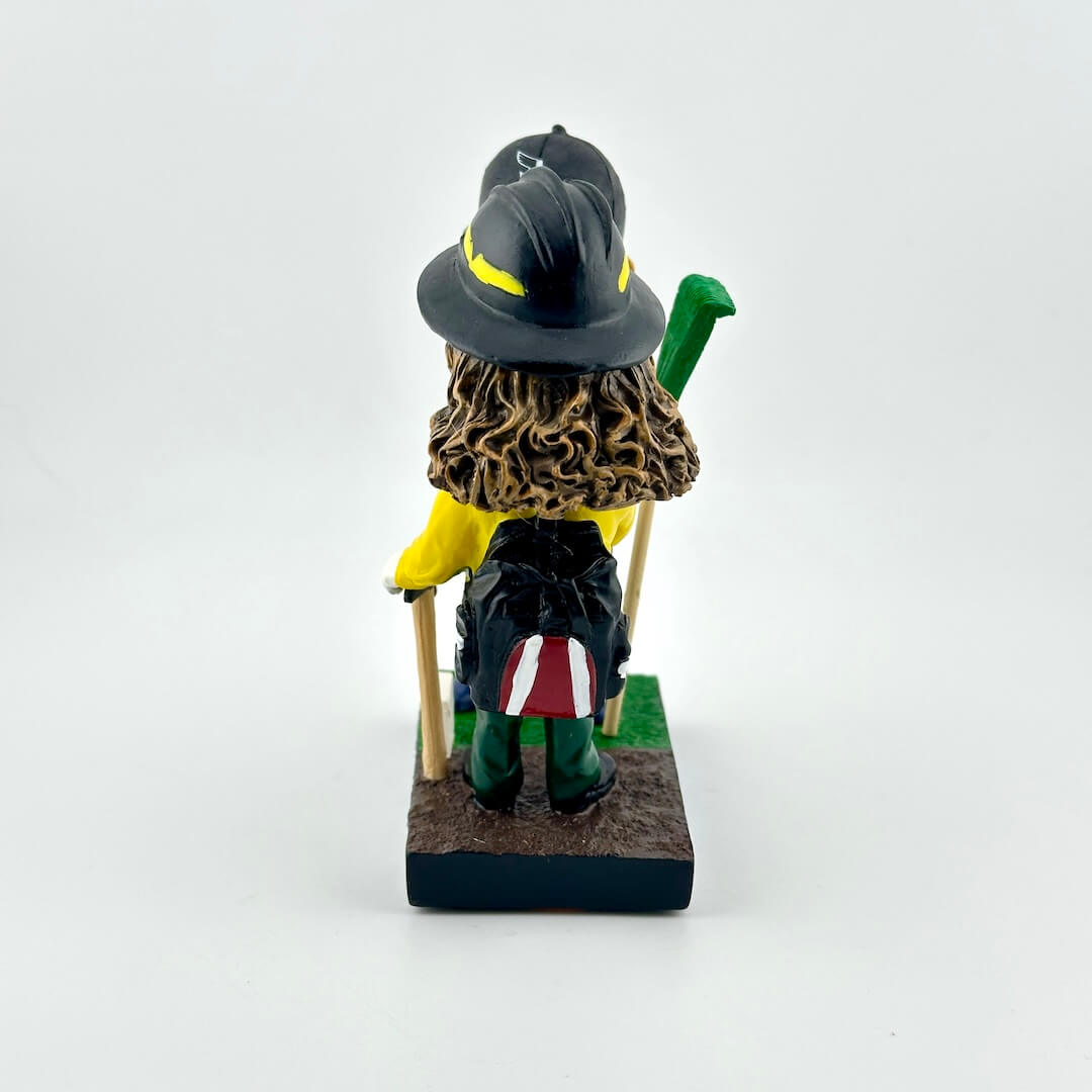 Bobblehead figure of a character with a hat and yellow shirt on a white background