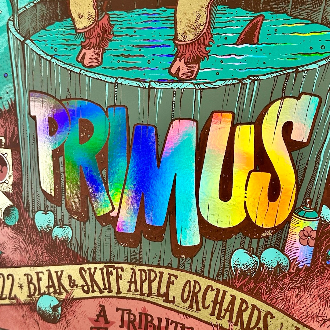 Close up of "PRIMUS" reflecting rainbow foil colors on turquoise background above red ground.